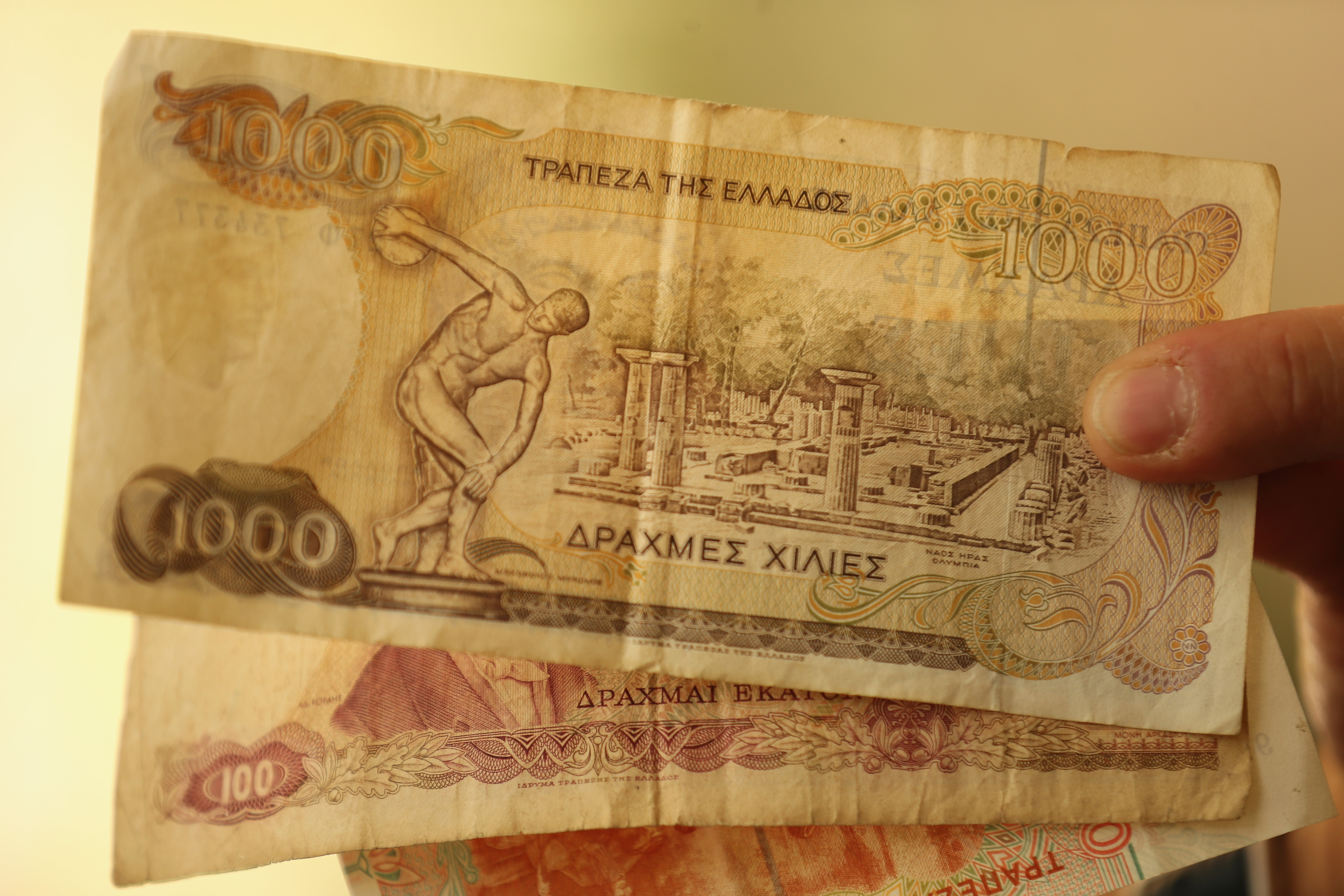 ATHENS, GREECE - JULY 07: A man holds Drachma notes, the currency in Greece before the Euro, on July 7, 2015 in Athens, Greece. Greek Prime Minister Alexis Tsipras is working on new debt crisis proposals and is due to present them at a Eurozone emergency summit today. (Photo by Christopher Furlong/Getty Images)
