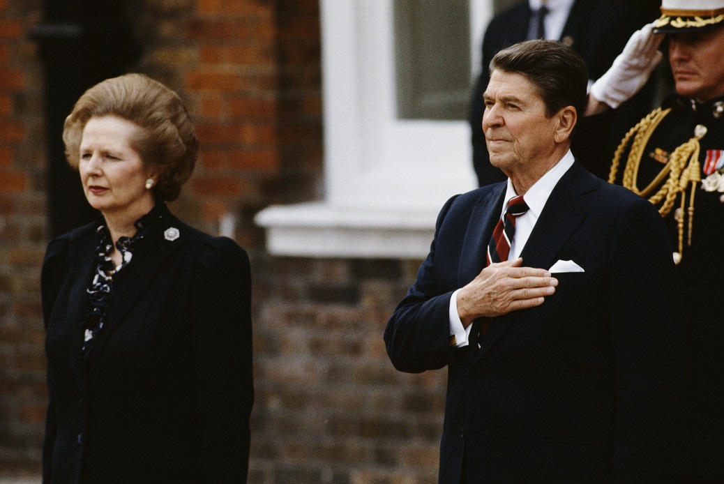 British Prime Minister Margaret Thatcher (centre, left) stands with US President Ronald Reagan (1911 - 2004, centre), as they listen to the American national anthem at Kensington Palace Gardens after Reagan's arrival from Ireland for the start of the 10th G7 Seven-Nation Economic Summit, London, 4th June 1984. (Photo by Bryn Colton/Getty Images)